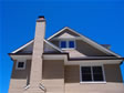 Exterior view of a two-story fireplace chimney from the backyard of this Monmouth County, Sea Girt, NJ modular home